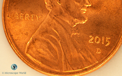 Penny under a stereo microscope at 7x magnification.