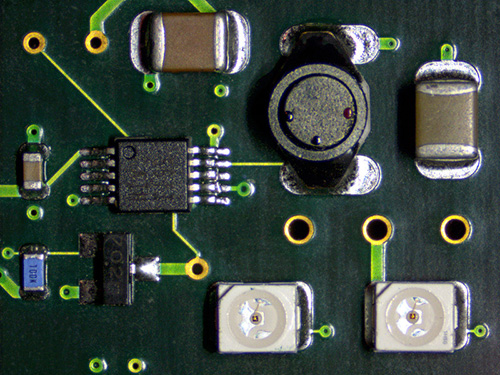 Circuit board under the stereo zoom microscope.