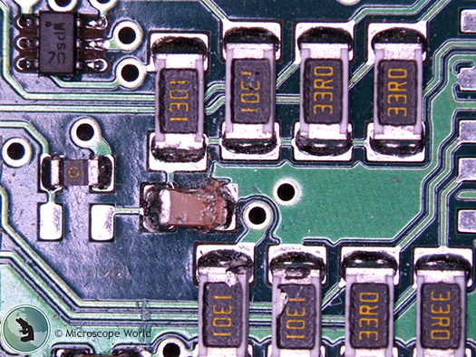 Circuit board under polarizing LED ring light.